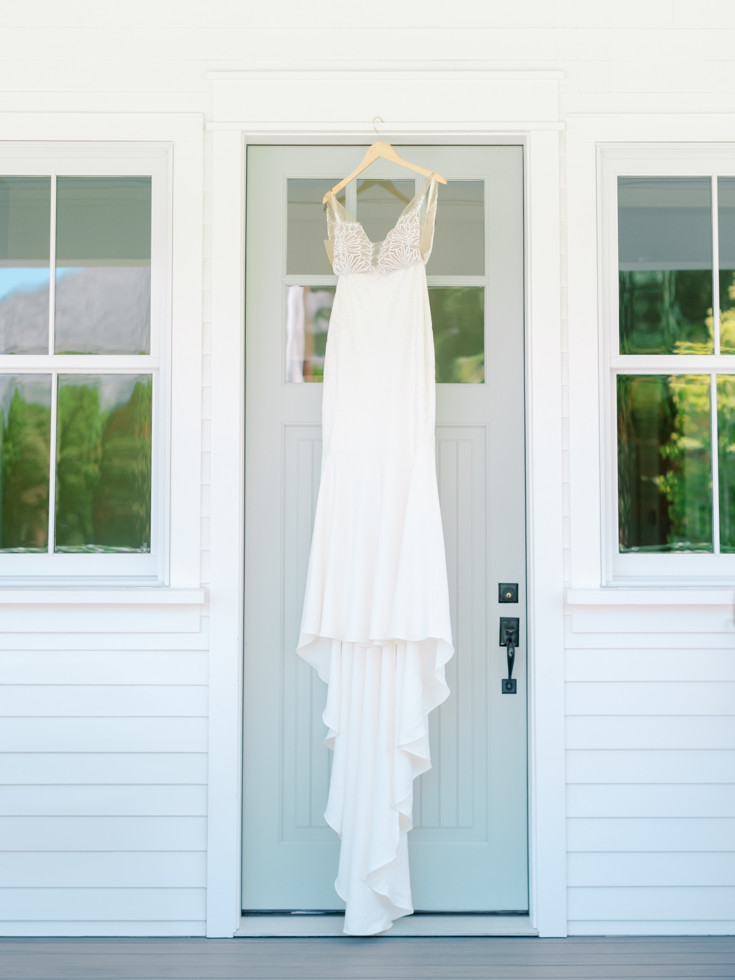 grace loves lace wedding dress hanging from door at harmony meadows wedding