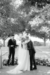 Bride and grooms first kiss at wedding ceremony at Abeja Winery