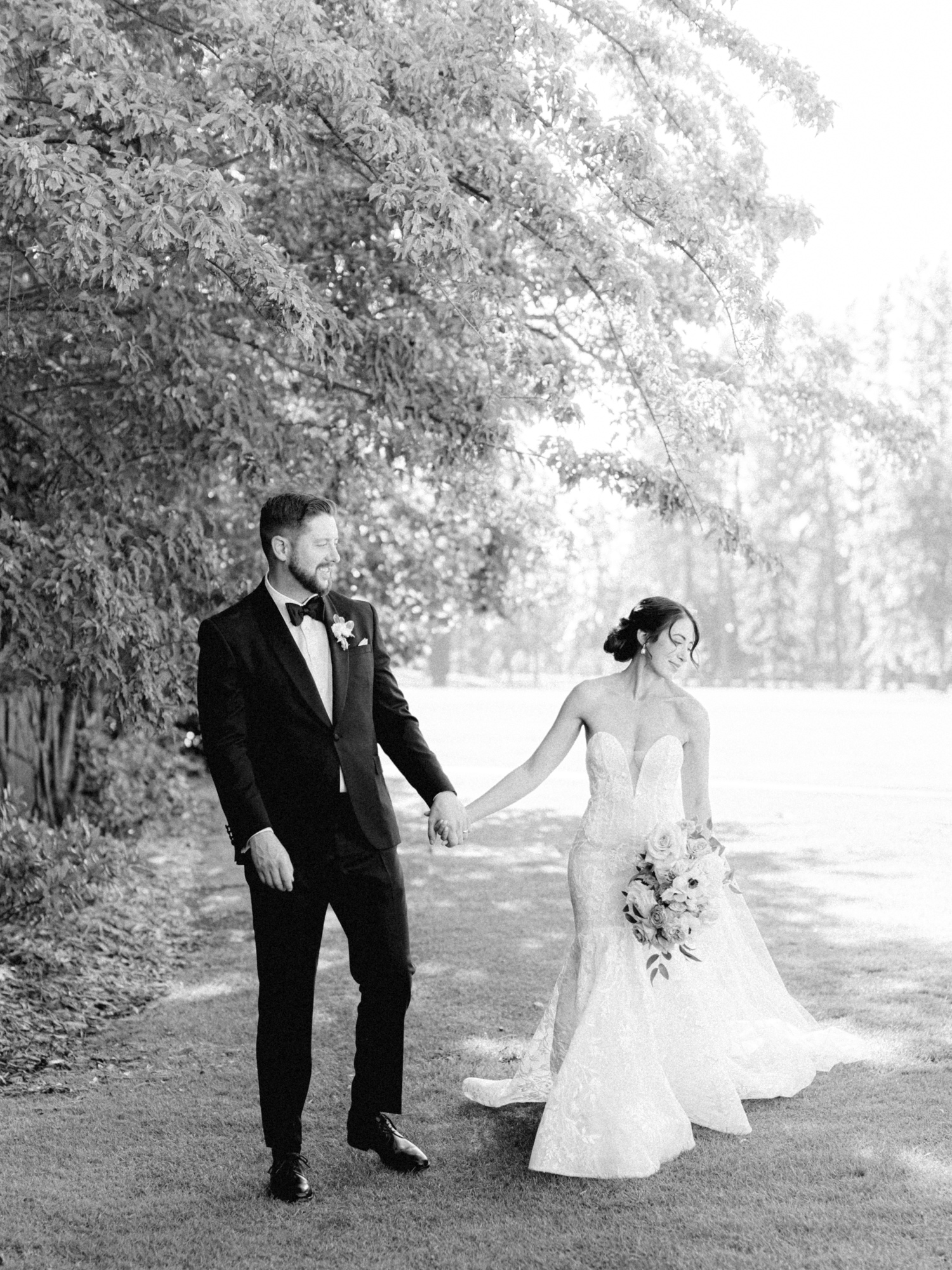 bride and groom walking property at hayden lake country club wedding
