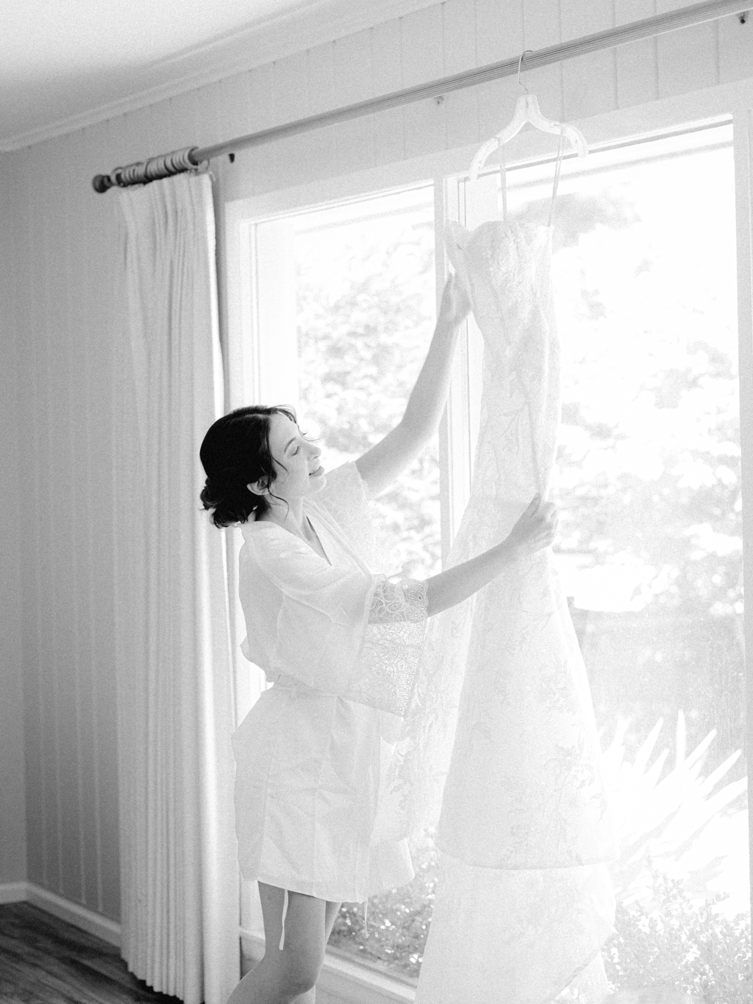 bride admiring her monique lhuillier wedding dress 