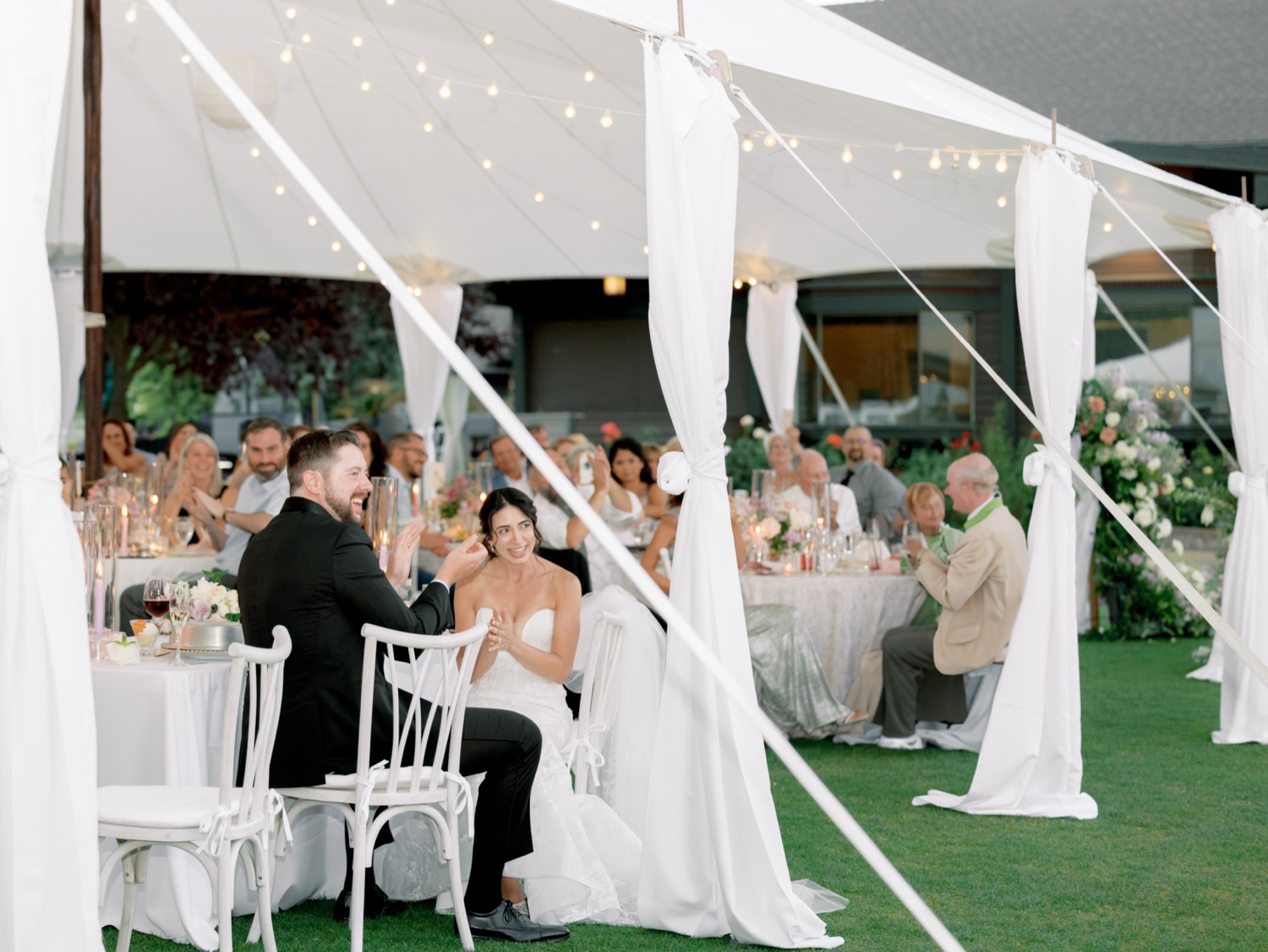 bride and groom clapping after speech during wedding reception at hayden lake country club