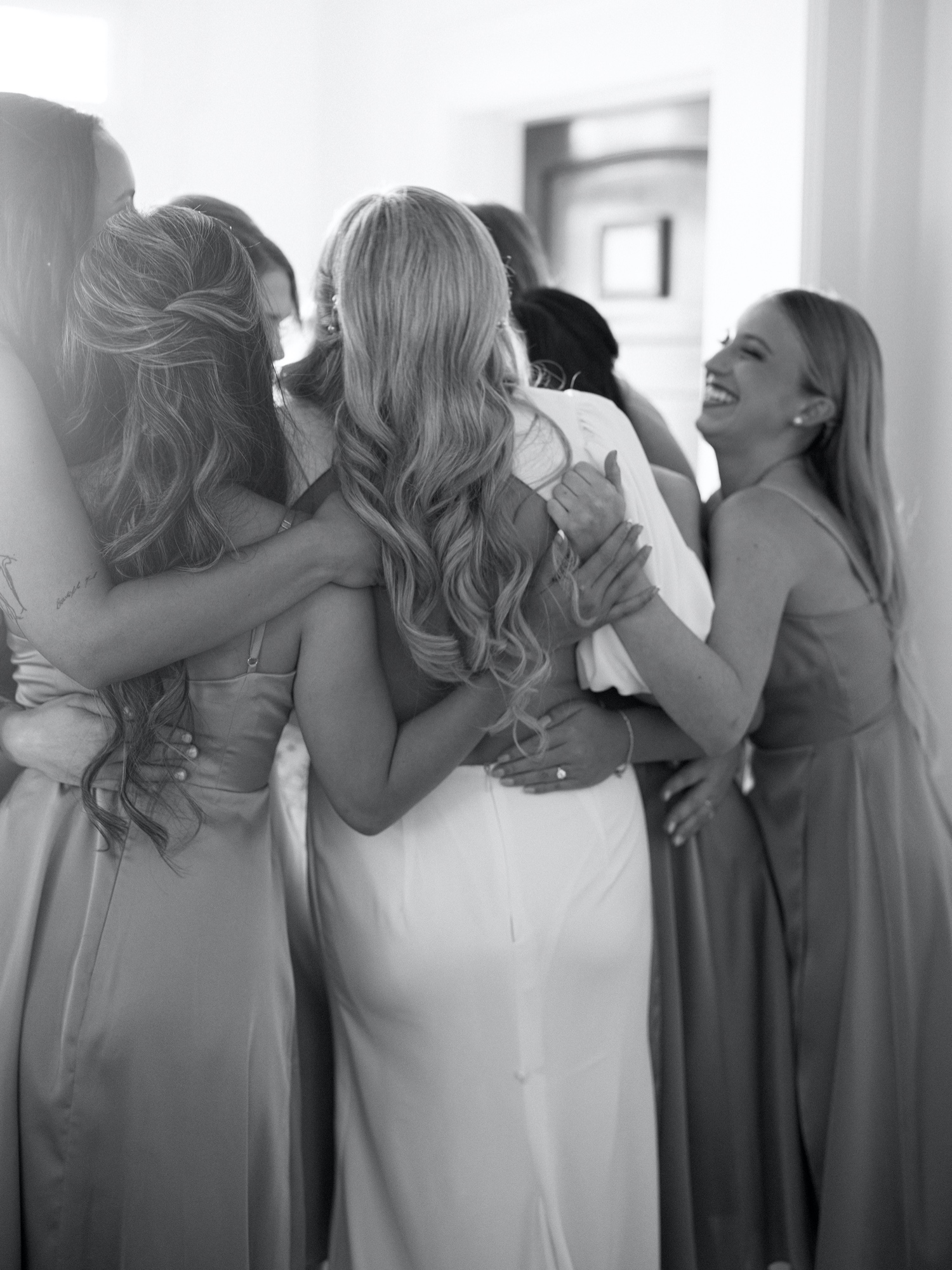 bridesmaids hugging bride for southern wedding at abeja winery