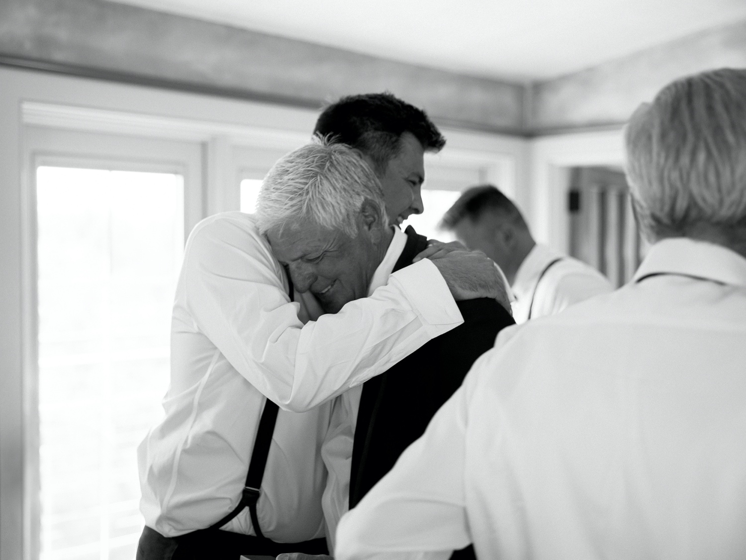 groom hugging father on his wedding day at abeja winery