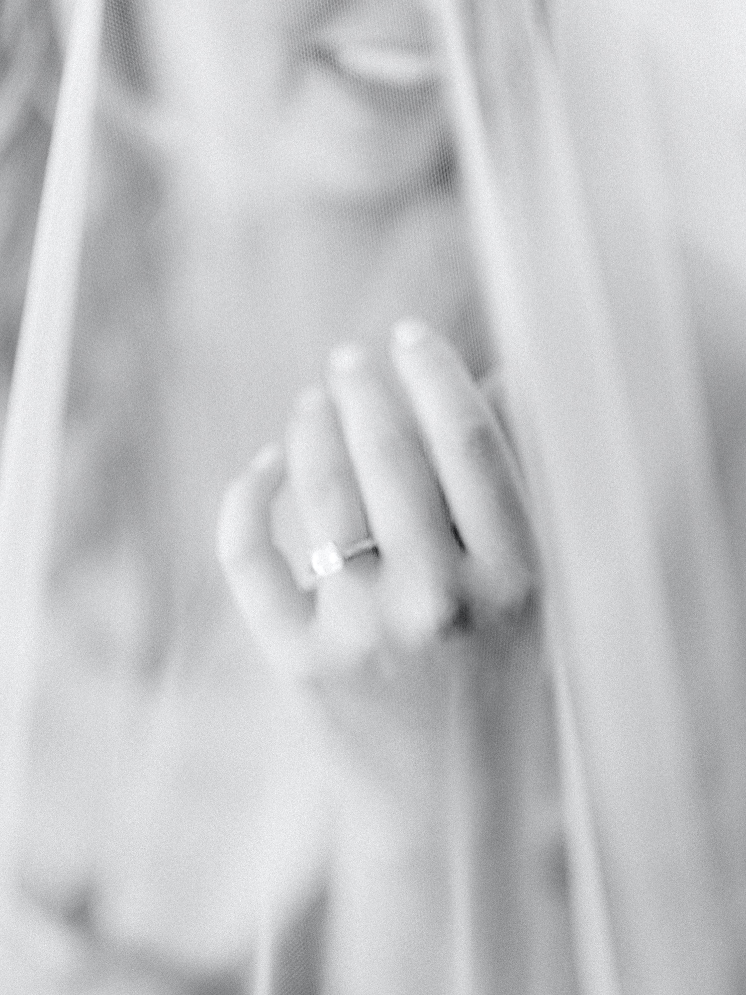 bride showing off engagement ring under her veil for abeja winery wedding
