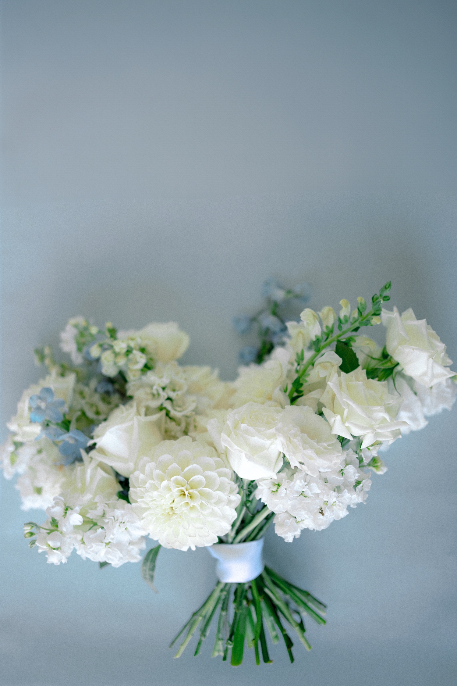 ivory bridal bouquet on blue backdrop for abeja winery wedding